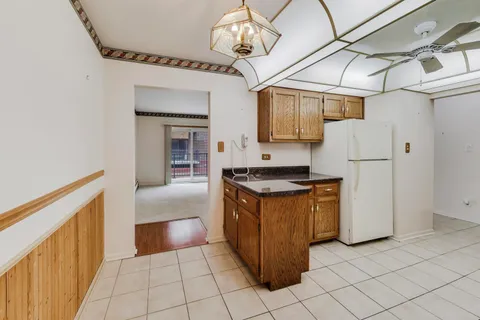 a kitchen with stainless steel appliances granite countertop a refrigerator and a stove