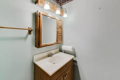 a bathroom with a sink a mirror and vanity