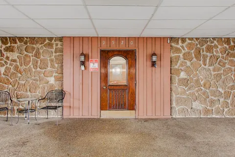 a view of a livingroom with a chair and a window
