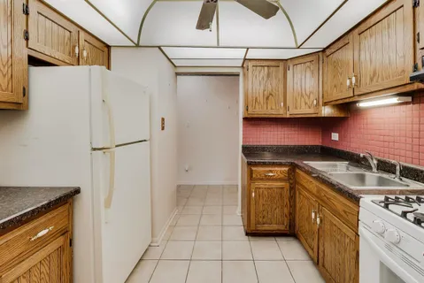 a kitchen with stainless steel appliances granite countertop a refrigerator and a stove