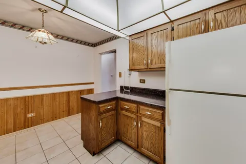 a kitchen with stainless steel appliances a refrigerator and a cabinets