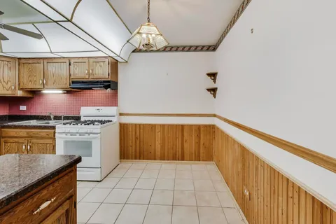 a kitchen with stainless steel appliances a stove top oven a sink and cabinets
