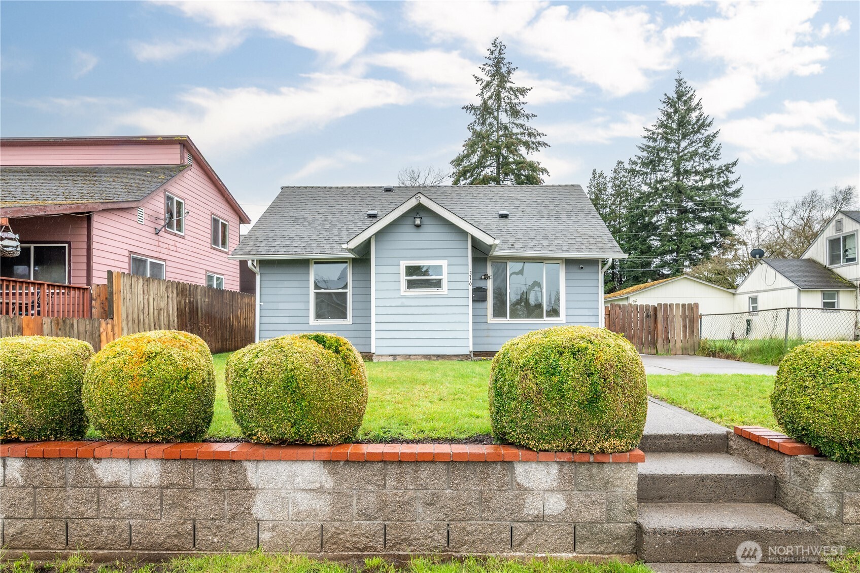 a front view of a house with garden