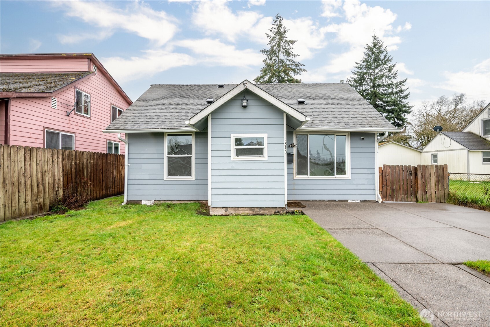 316 15th Avenue Longview, WA 98632 - Photo 3 of 30 a front view of a house with a yard and garage
