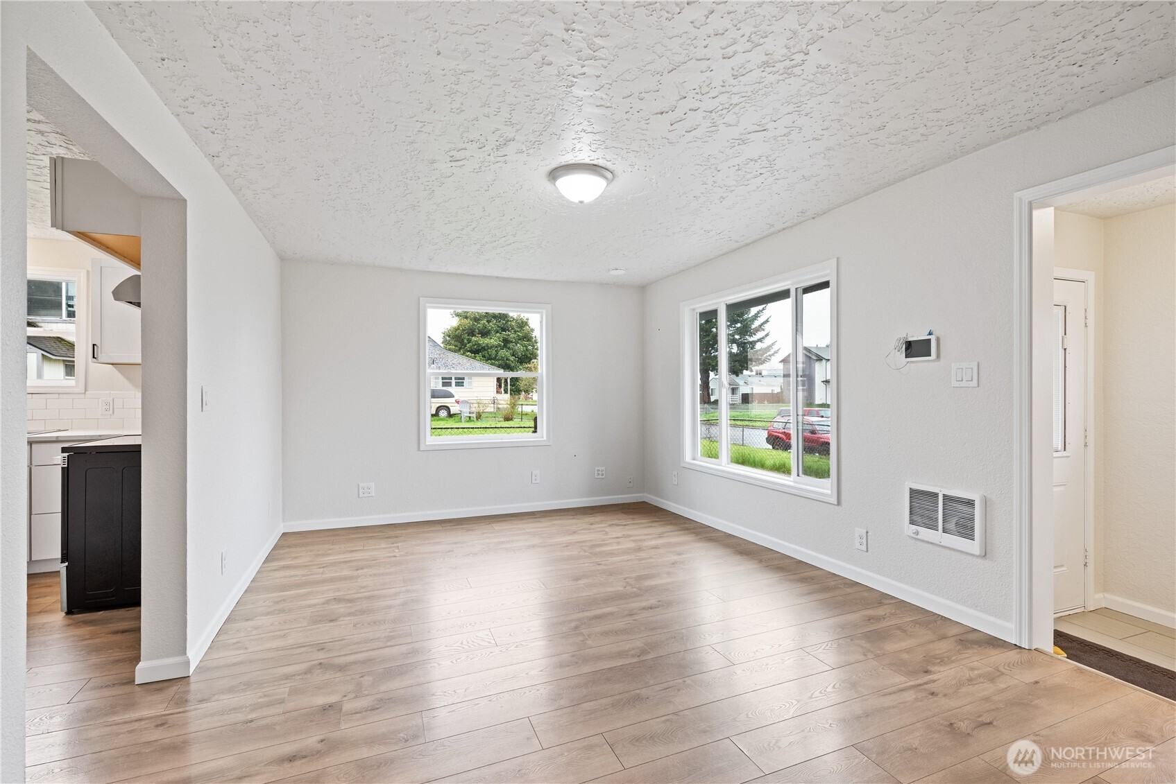 316 15th Avenue Longview, WA 98632 - Photo 6 of 30 an empty room with wooden floor and windows