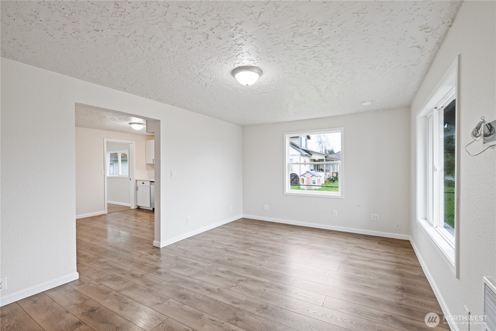 316 15th Avenue Longview, WA 98632 - Photo 7 of 30 an empty room with wooden floor and windows