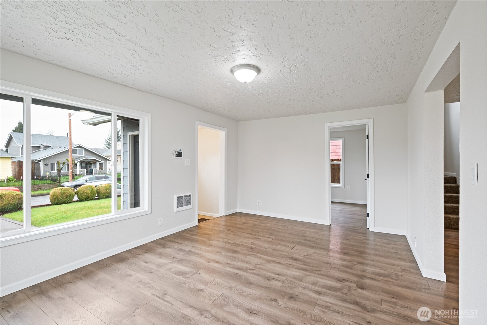 316 15th Avenue Longview, WA 98632 - Photo 9 of 30 a view of an empty room with wooden floor and a window