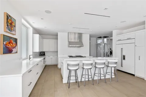 a living room with furniture potted plant and a large window