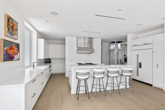 a living room with furniture potted plant and a large window