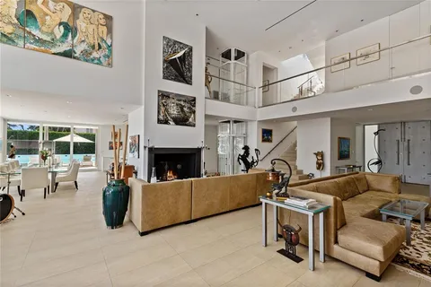 a front view of a house with swimming pool having outdoor seating