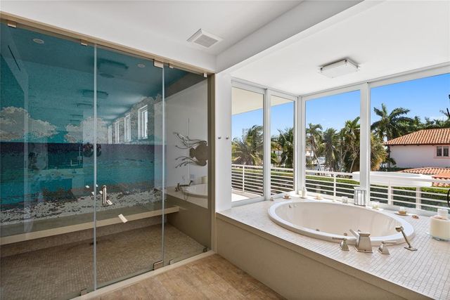 a view of a kitchen with kitchen island a stove a sink and dishwasher with wooden floor