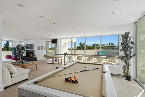 a swimming pool with outdoor seating and city view