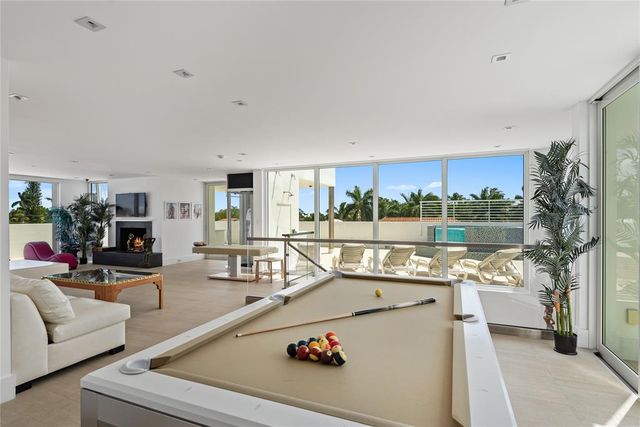 a swimming pool with outdoor seating and city view