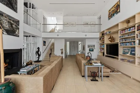 a view of a dining room with furniture water view and backyard of the house