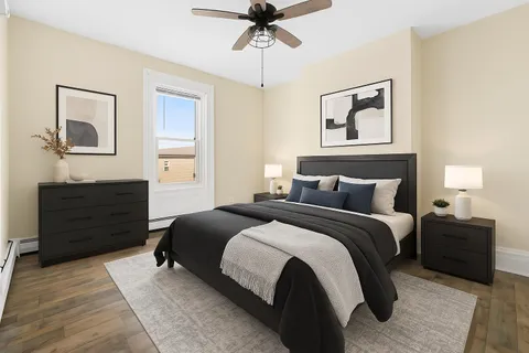 a bedroom with bed and window