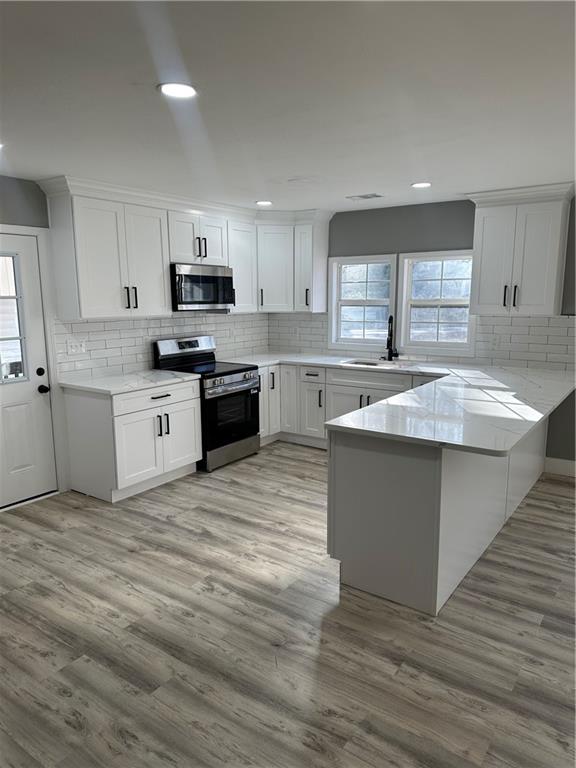 404 Walker Drive Monroe, GA 30655 - Photo 2 of 5 a kitchen with stainless steel appliances granite countertop a sink and cabinets