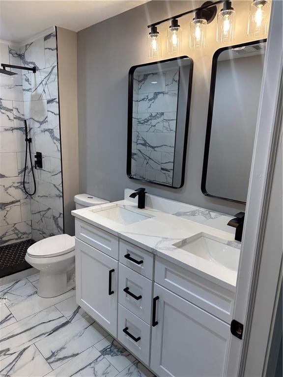 404 Walker Drive Monroe, GA 30655 - Photo 5 of 5 a bathroom with a granite countertop sink a toilet and a mirror