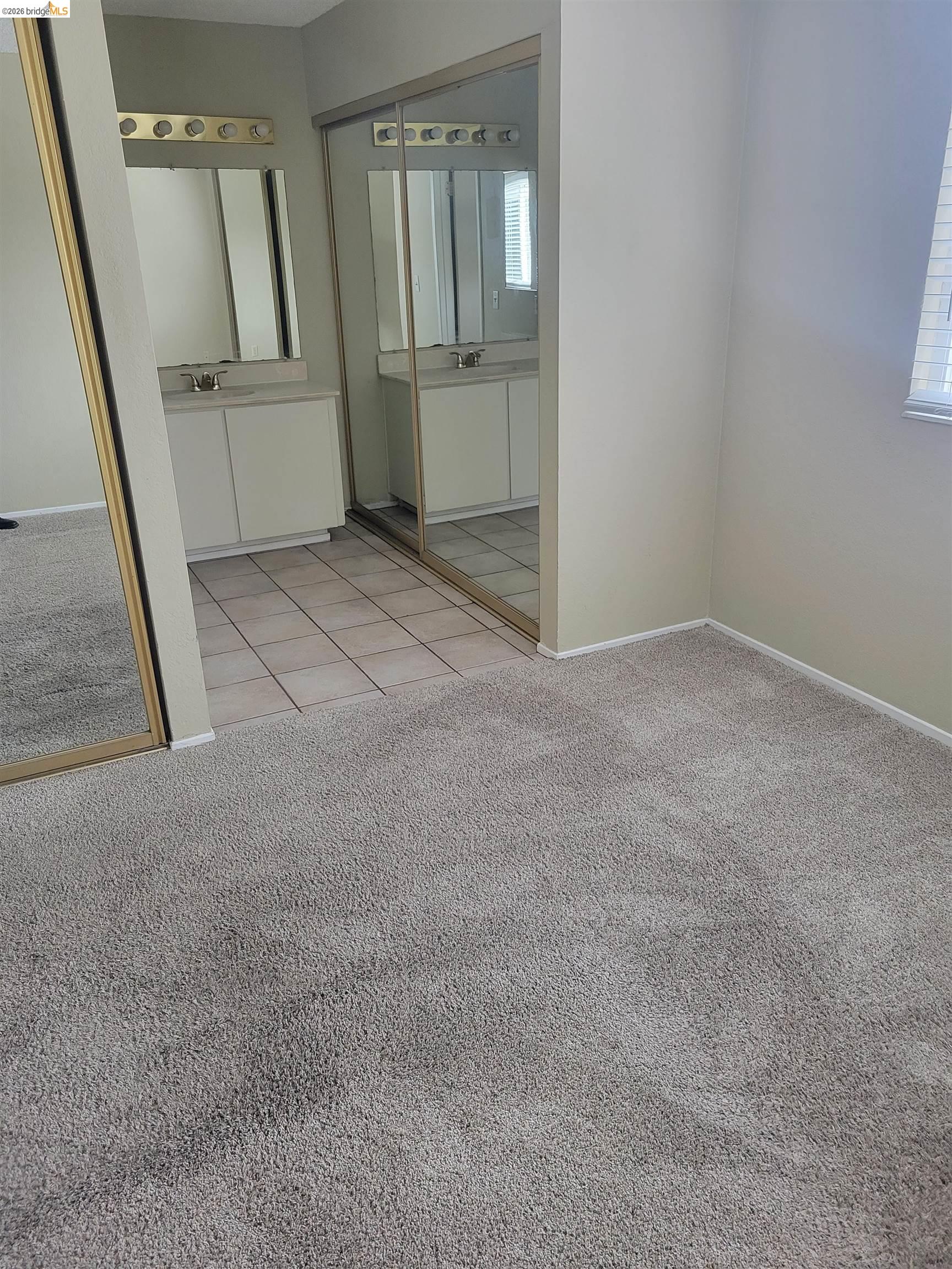 906 Coral Drive Rodeo, CA 94572 - Photo 11 of 21 an empty room with mirror on the side of a house