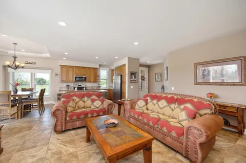 a spacious en suite bathroom with a granite countertop tub and a sink
