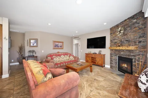 a bathroom with a granite countertop sink a toilet a mirror and shower