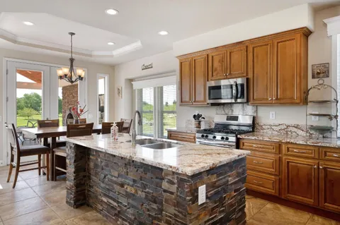 a view of brick house with a yard