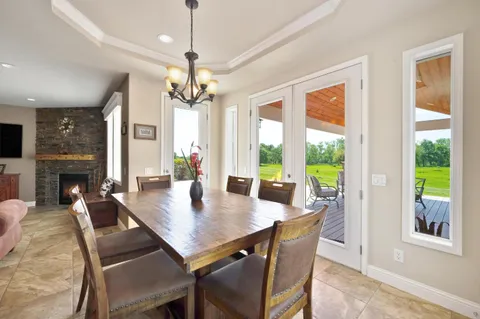 a living room with furniture and a chandelier