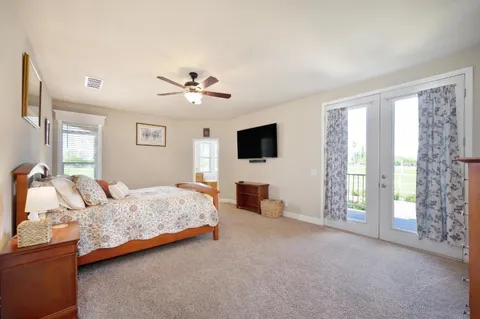 a view of a swimming pool with a lawn chairs and plants