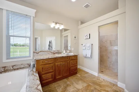 a view of a swimming pool with a lawn chairs and palm trees
