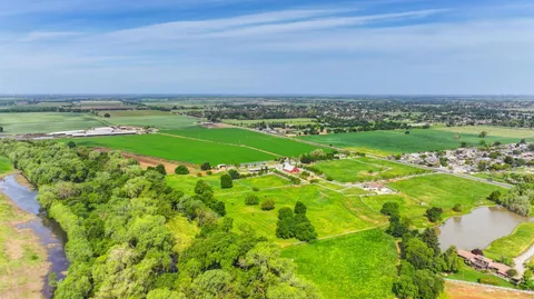 a kitchen with stainless steel appliances granite countertop a sink stove microwave and refrigerator