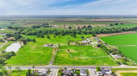 a swimming pool with barbeque oven outdoor seating and yard