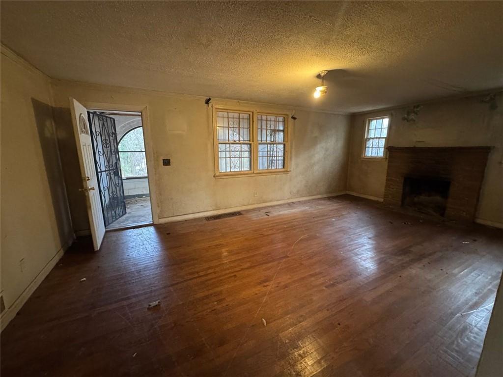 1096 3rd Street Northwest Atlanta, GA 30318 - Photo 14 of 17 an empty room with wooden floor and windows