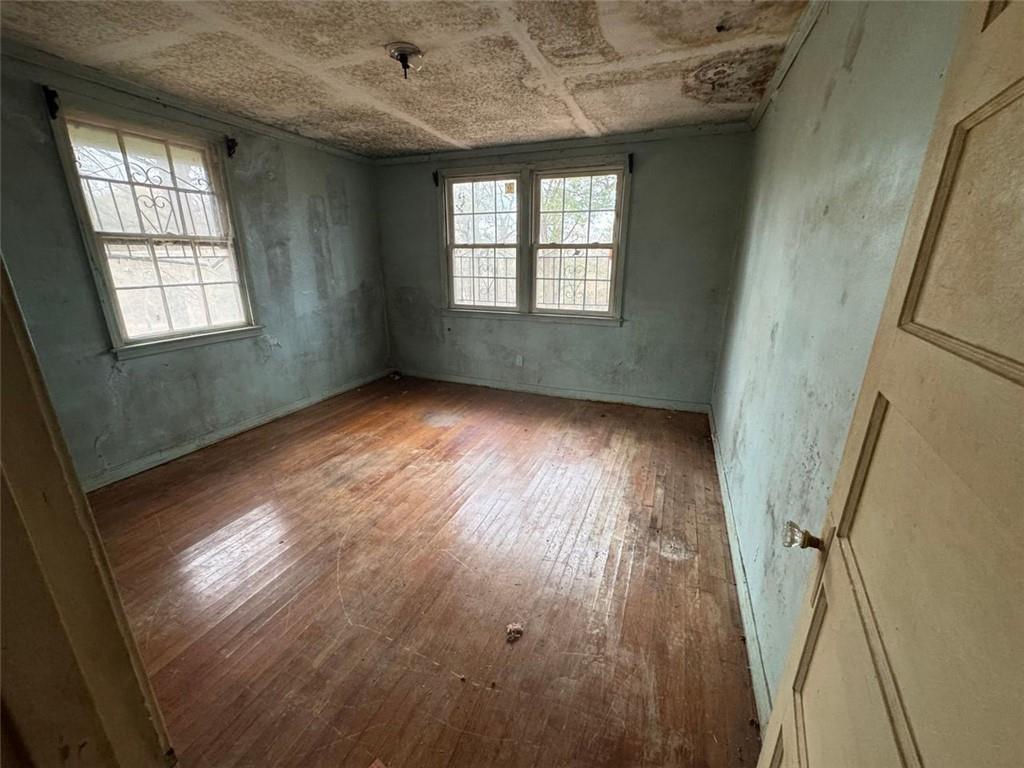 1096 3rd Street Northwest Atlanta, GA 30318 - Photo 16 of 17 an empty room with wooden floor and windows