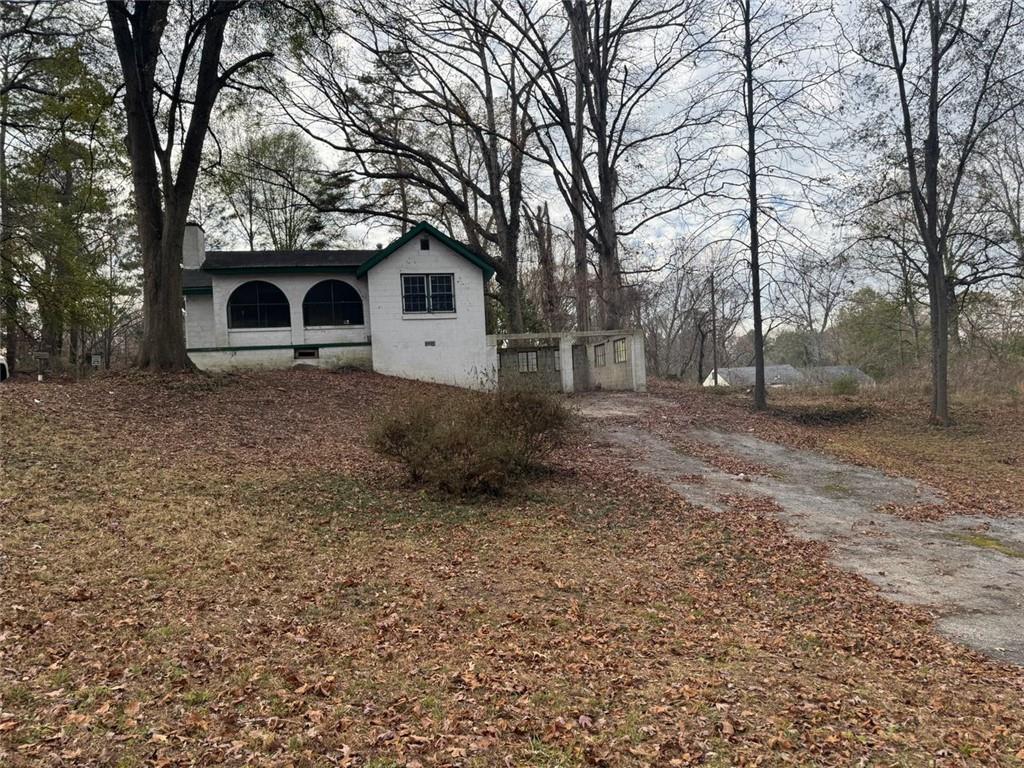 1096 3rd Street Northwest Atlanta, GA 30318 - Photo 8 of 17 a view of a yard in front of a house with large trees