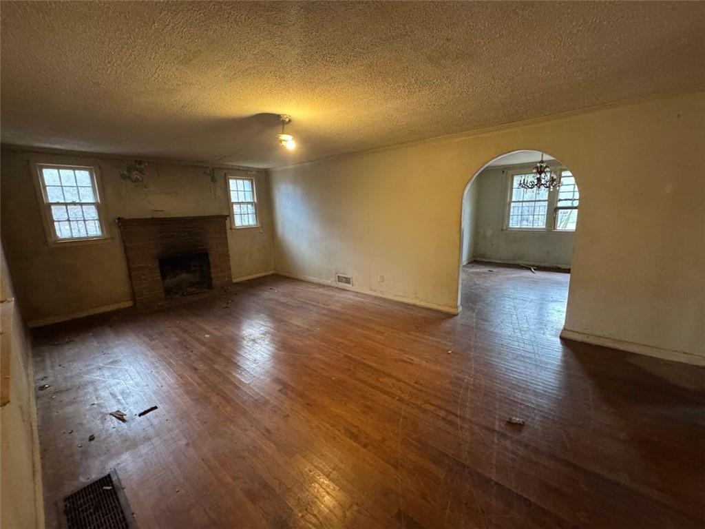 1096 3rd Street Northwest Atlanta, GA 30318 - Photo 10 of 17 an empty room with wooden floor fireplace and windows