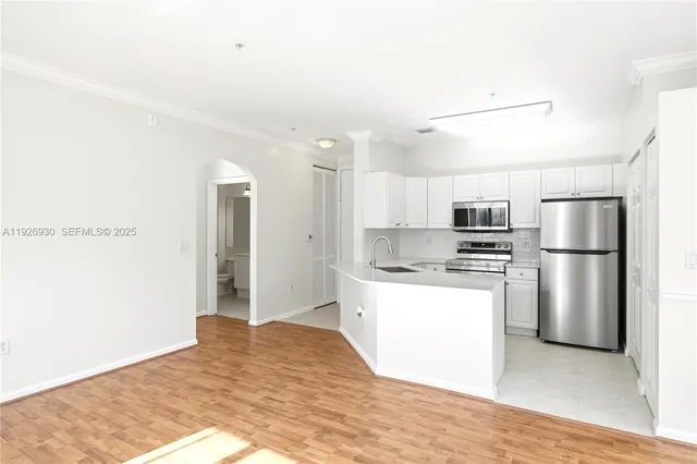 a kitchen with stainless steel appliances a refrigerator and a stove