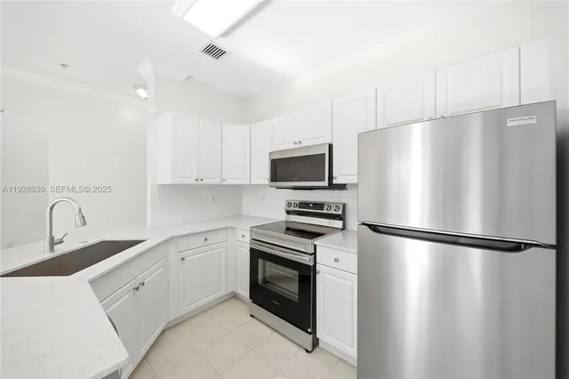 a kitchen with stainless steel appliances a refrigerator sink and microwave