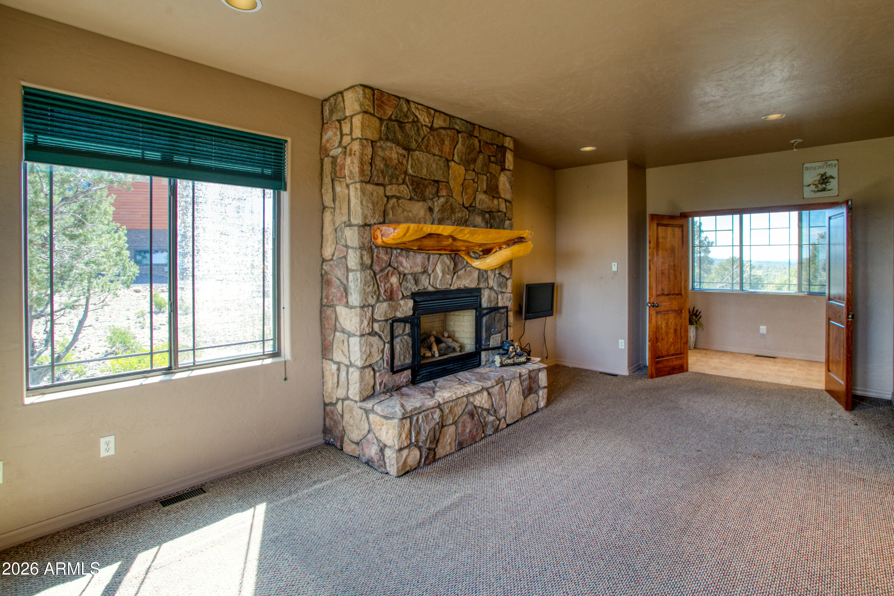 1511 South Canyon Ridge Trail Show Low, AZ 85901 - Photo 20 of 61 a view of an empty room with a fireplace and a window