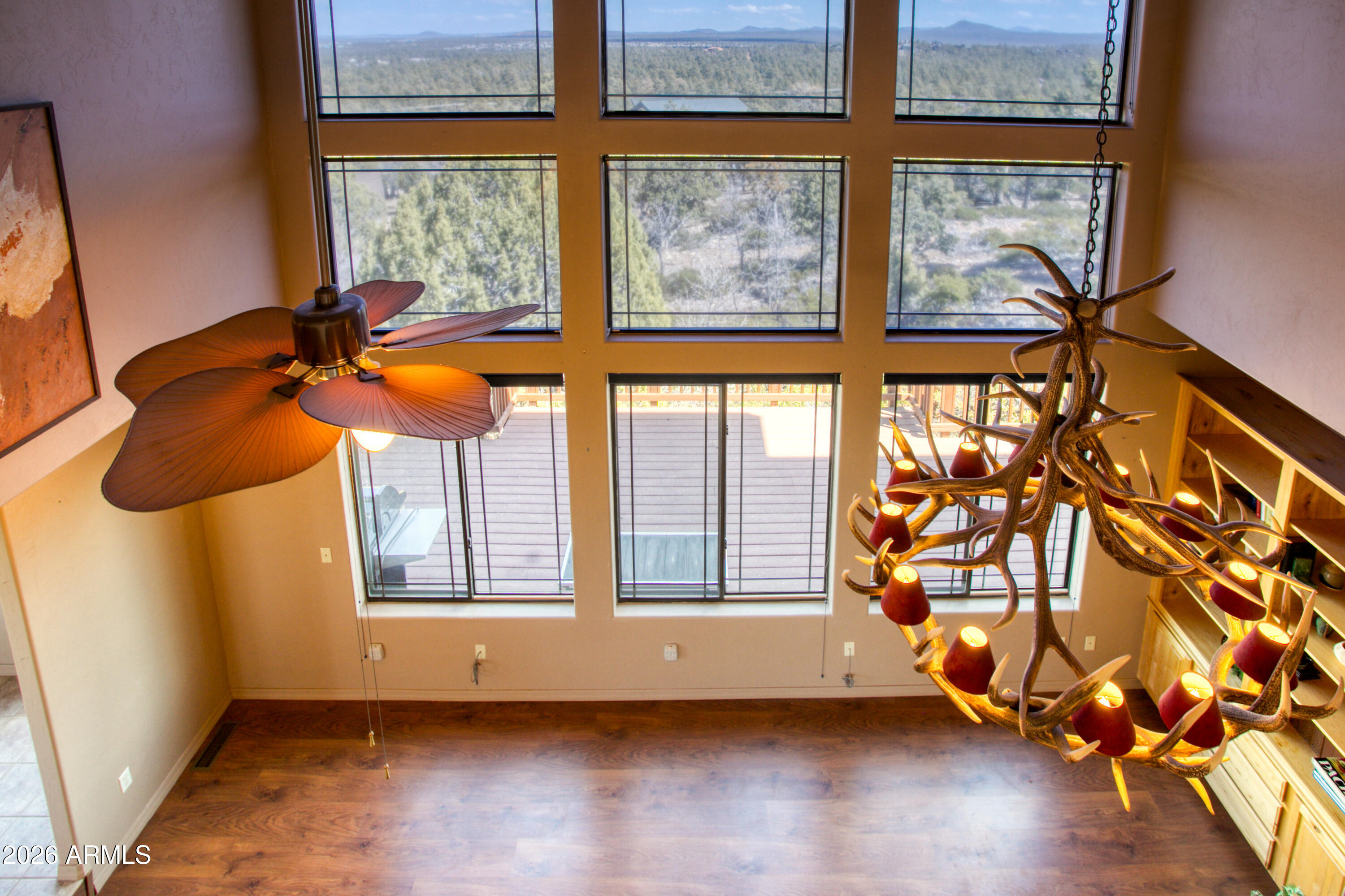 1511 South Canyon Ridge Trail Show Low, AZ 85901 - Photo 30 of 61 a view of an empty room with wooden floor and windows