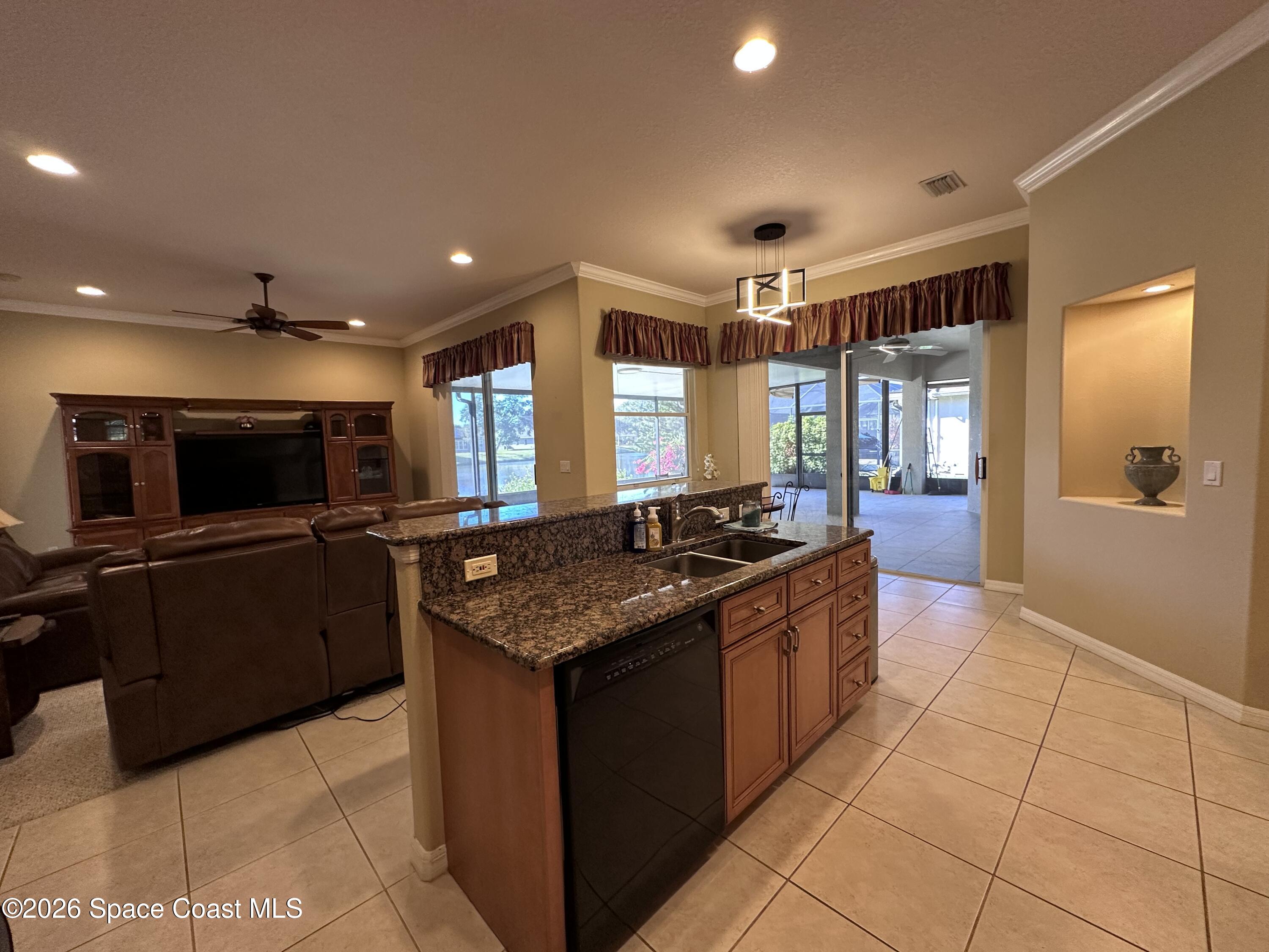 883 Spring Oak Drive Melbourne, FL 32901 - Photo 23 of 43 a kitchen with stainless steel appliances granite countertop a stove and a sink
