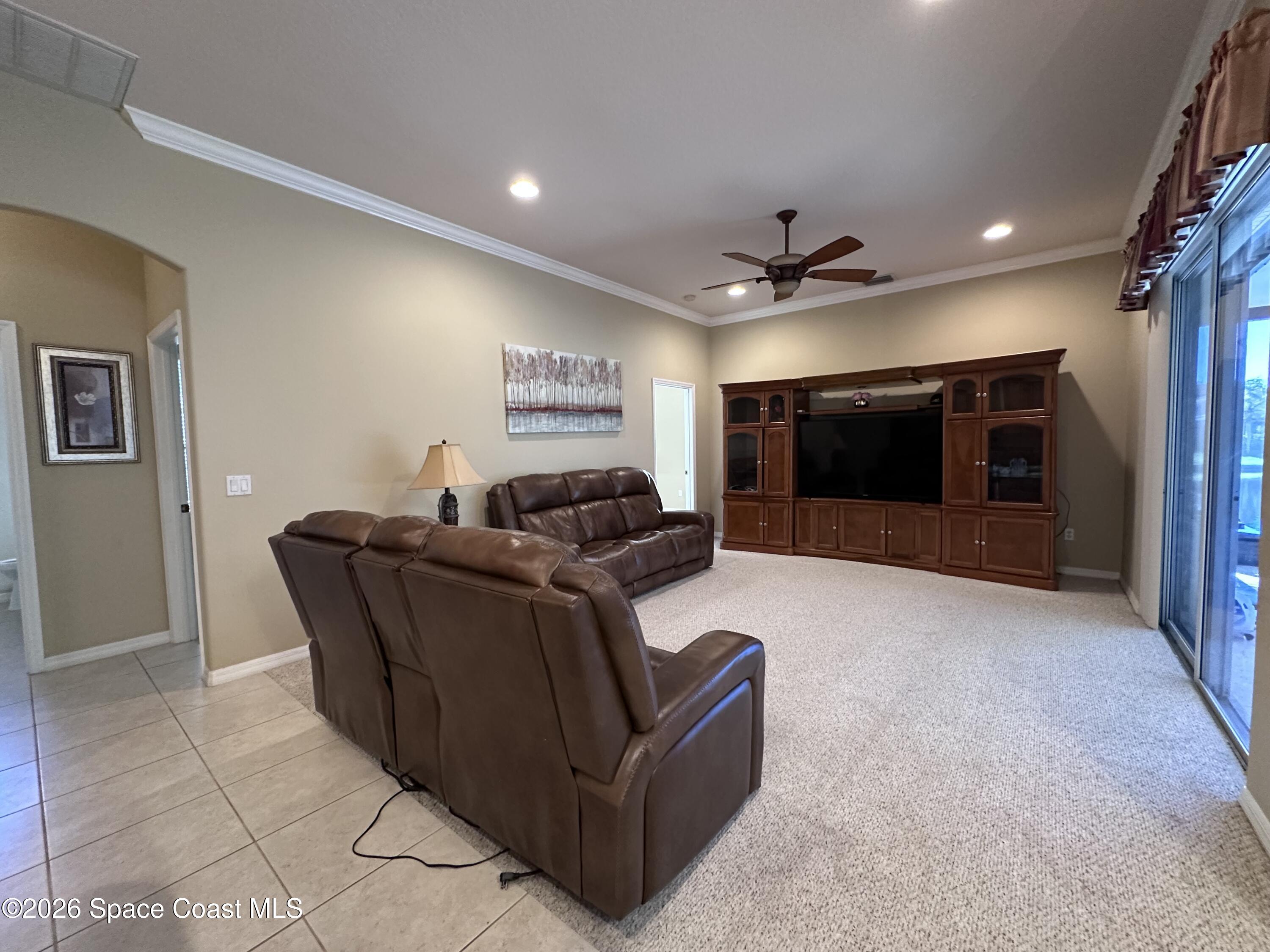 883 Spring Oak Drive Melbourne, FL 32901 - Photo 25 of 43 a living room with furniture and a flat screen tv