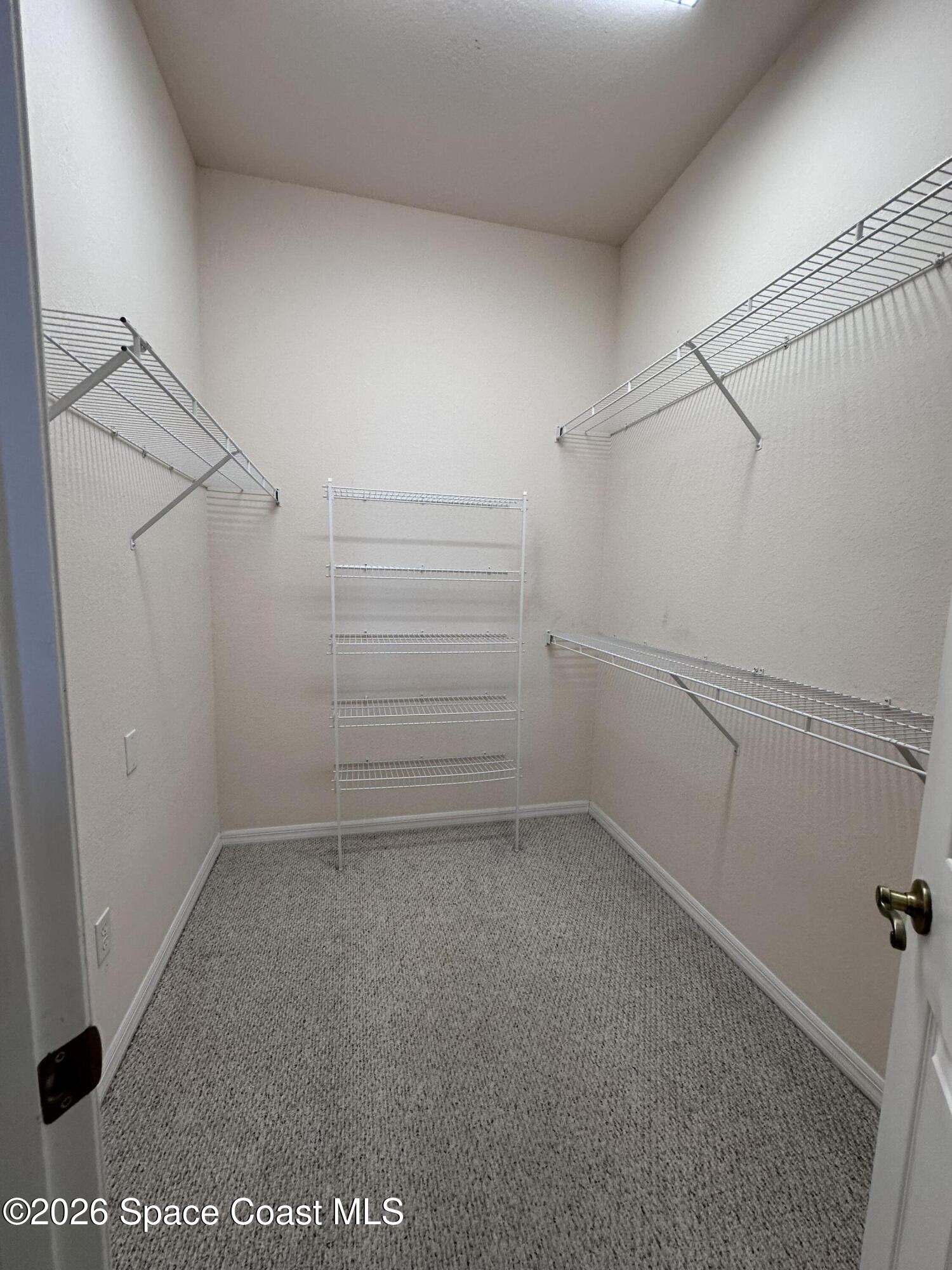 883 Spring Oak Drive Melbourne, FL 32901 - Photo 10 of 43 a view of a room with racks on the wall