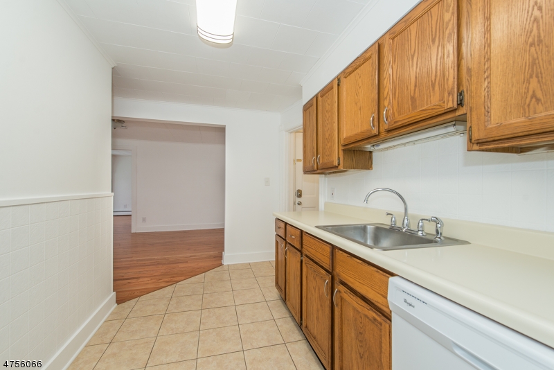 55 Madison Street, Unit 3 Newton, NJ 07860 - Photo 4 of 15 a kitchen with stainless steel appliances granite countertop a sink and cabinets