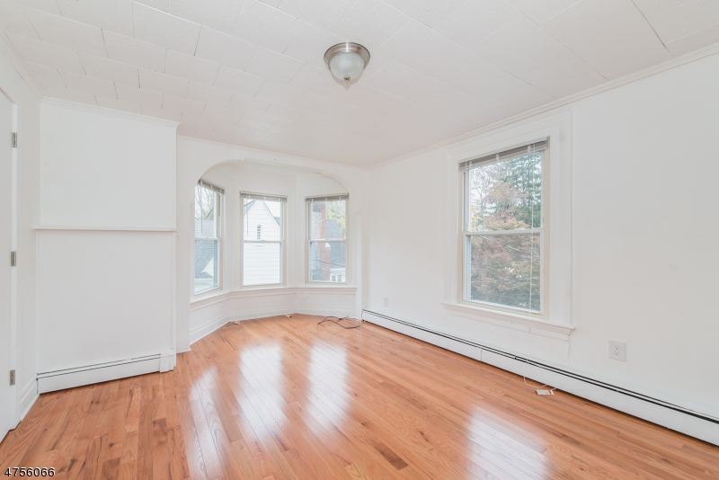 55 Madison Street, Unit 3 Newton, NJ 07860 - Photo 8 of 15 an empty room with wooden floor and windows