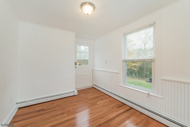 55 Madison Street, Unit 3 Newton, NJ 07860 - Photo 10 of 15 an empty room with wooden floor and windows