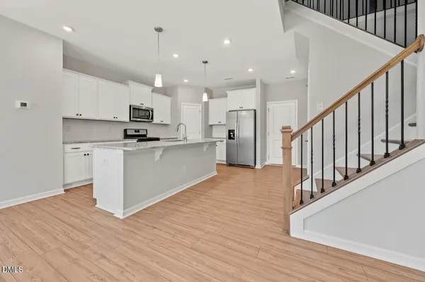 a view of kitchen with wooden floor and electronic appliances