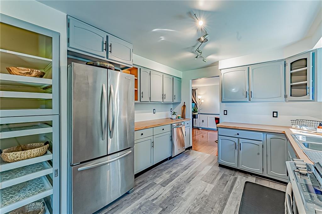 1858 Sample Road Allison Park, PA 15101 - Photo 11 of 25 a kitchen with granite countertop stainless steel appliances and wooden cabinets