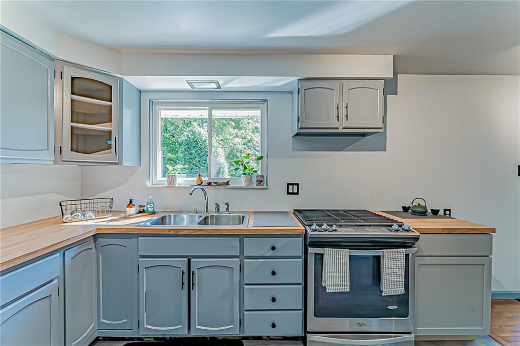 1858 Sample Road Allison Park, PA 15101 - Photo 12 of 25 a kitchen with sink a window and cabinets