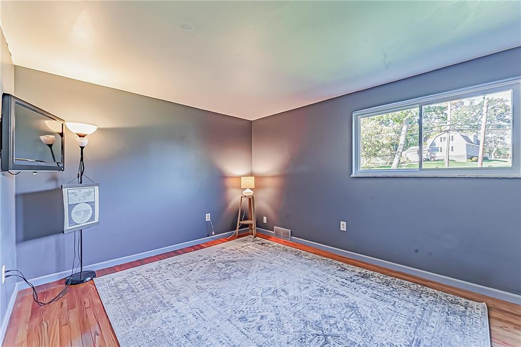 1858 Sample Road Allison Park, PA 15101 - Photo 21 of 25 a view of empty room with window and wooden floor