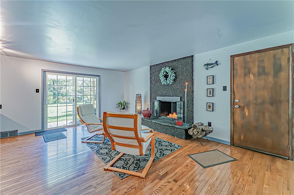 1858 Sample Road Allison Park, PA 15101 - Photo 6 of 25 a living room with furniture a fireplace and a table with wooden floor