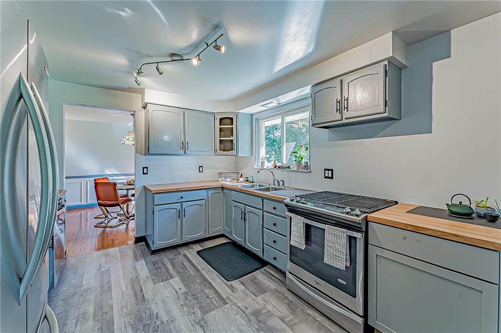 1858 Sample Road Allison Park, PA 15101 - Photo 10 of 25 a kitchen with stainless steel appliances granite countertop a stove sink and cabinets